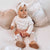 Baby girl wearing adorable knit heart baby romper from Lulu Babe