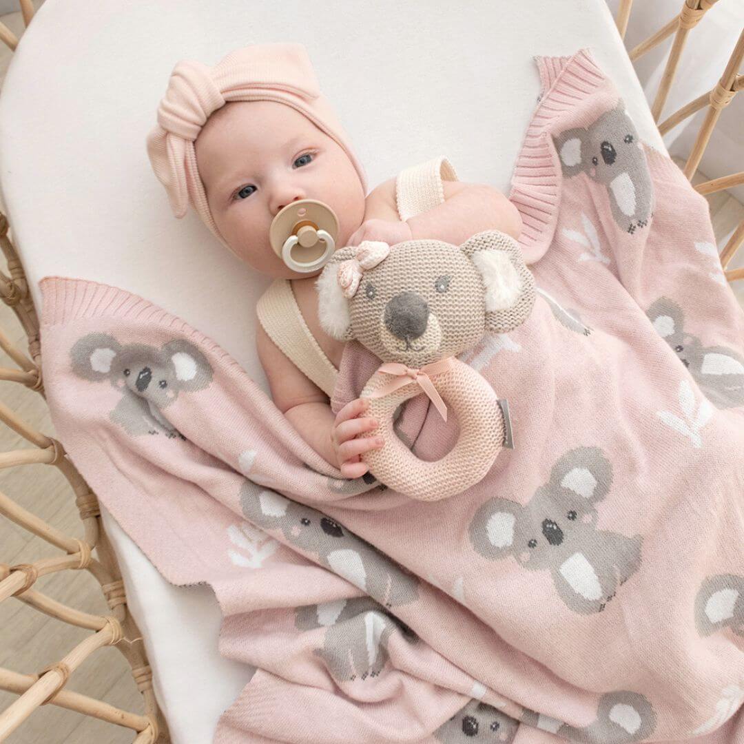 Baby wrapped in a pink koala baby blanket, 100% cotton knit.