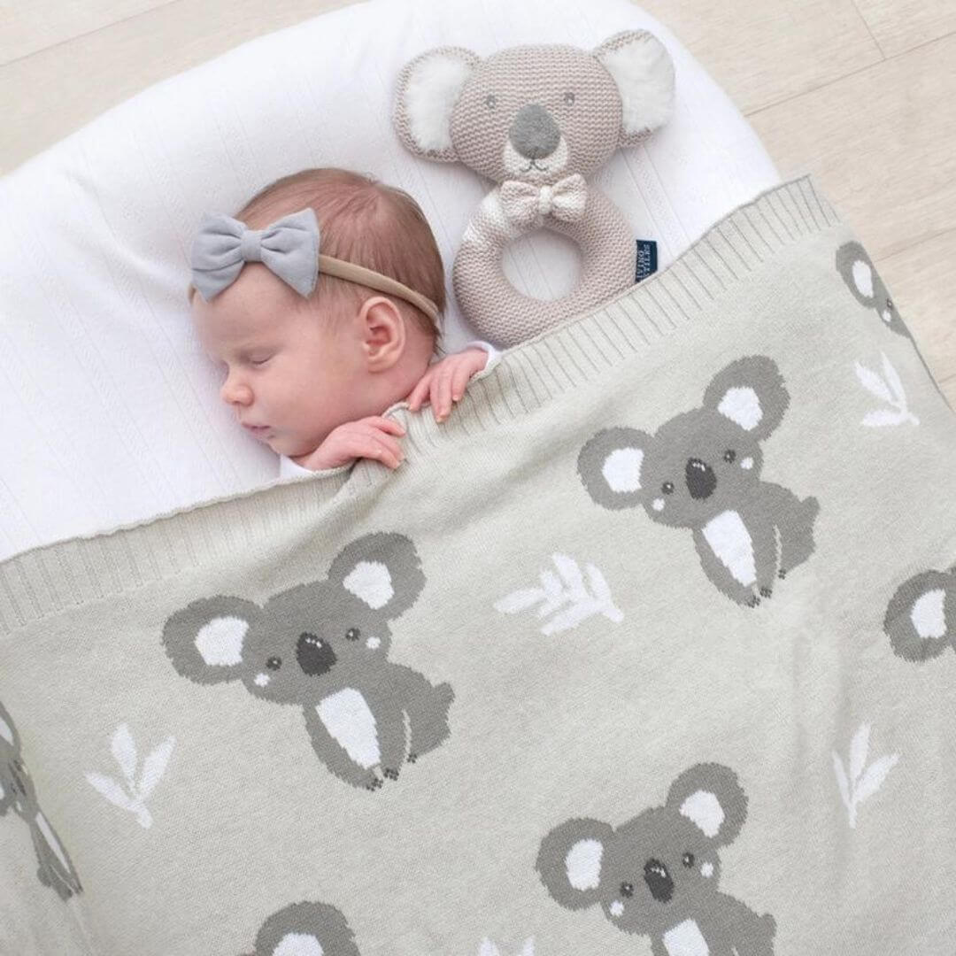Baby sleeping under a grey koala baby blanket in 100% cotton knit - Australian baby gift