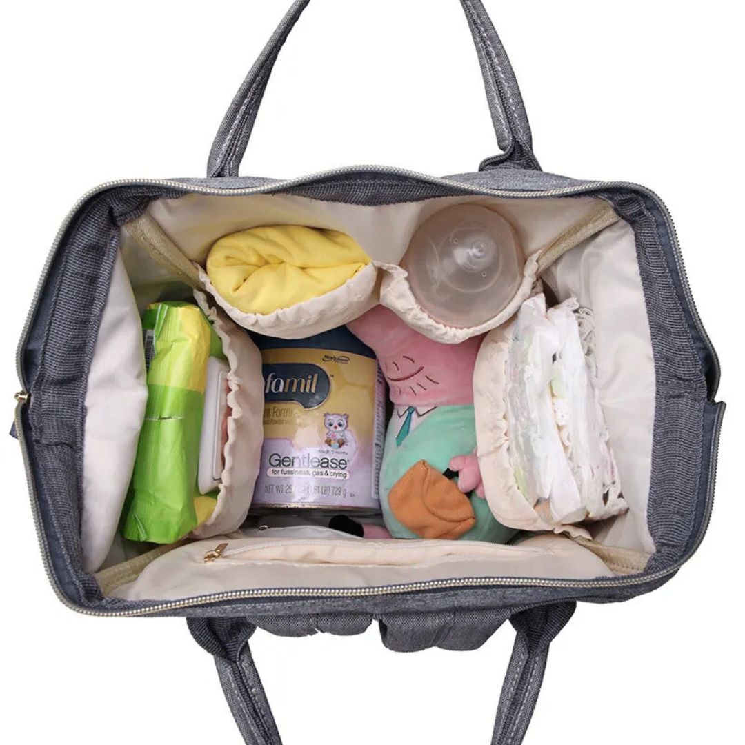Inside view of the LeQueen Nappy Bag showing organized compartments for baby's essentials and personal items.