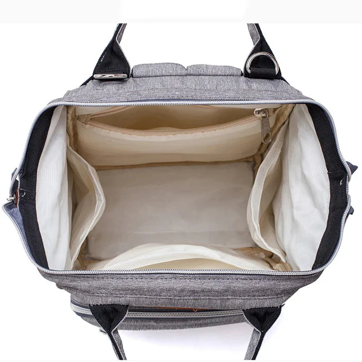 Spacious interior view of the LeQueen Quilted Nappy Backpack with multiple compartments for organised storage.