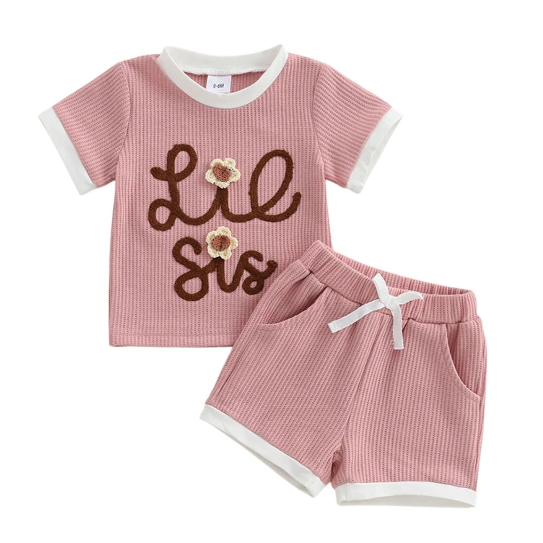 Lil Sis Pink Shorts Set featuring a pink waffle-textured top and matching shorts with pockets, perfect for playtime.