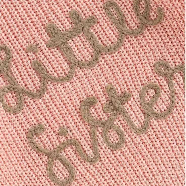 Closeup of embroidery on pink Little Sister jumper