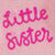 Little Sister Pink Jumper with embroidered text 'Little Sister' on soft knitted fabric.
