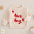 Beige baby knit jumper with red "love bug" and heart embroidery