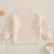 Beige baby knit jumper with "love bug" embroidery - back view