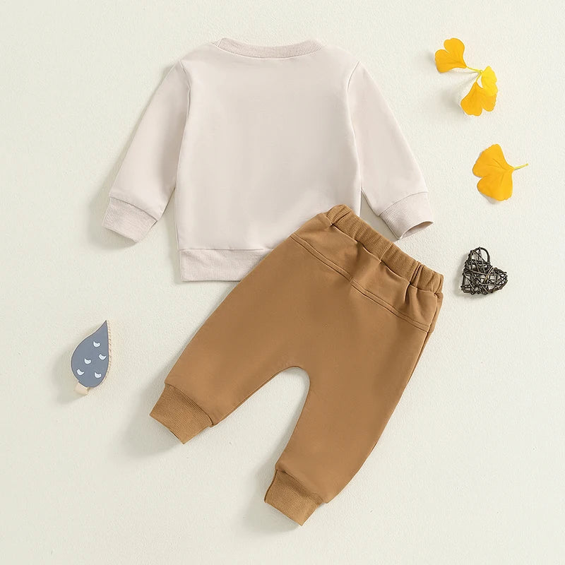 Back view of "Mama's Little Bestie" baby tracksuit in beige and mustard