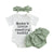 Baby girl outfit with 'Mama's little reading buddy' bodysuit, green ruffled bloomers, and headband.