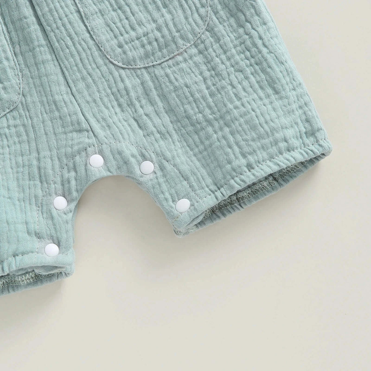Cotton muslin baby romper in sage - closeup view