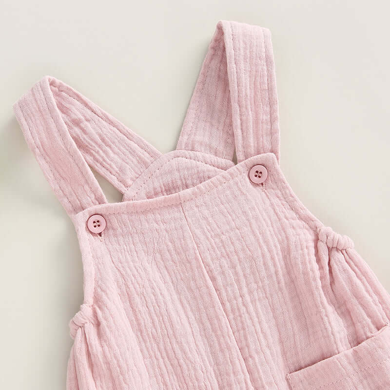 Cotton muslin baby romper in blush pink - closeup of straps