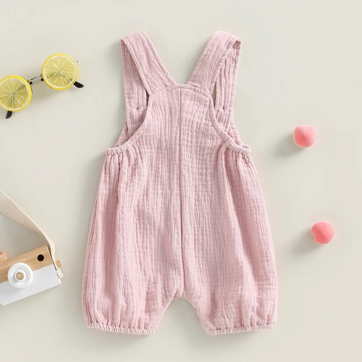 Cotton muslin baby romper in blush pink - rear view