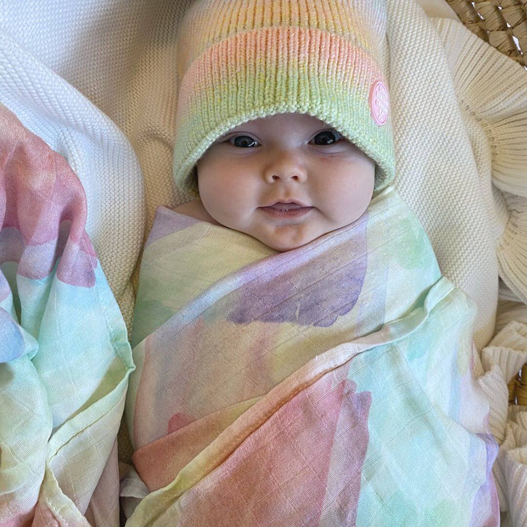 Baby wrapped in muslin swaddle by Little Renegade Company