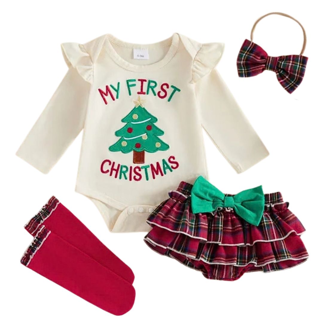 Flat lay of a 4-piece baby girl Christmas outfit set featuring a long-sleeve bodysuit with "My First Christmas" design, red tiered tartan ruffle bloomer skirt, matching bow headband, and red knee-high socks