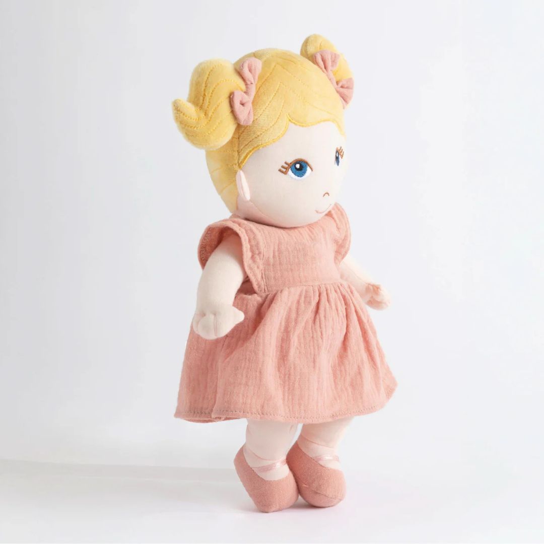 My First Doll - Lola, a soft doll with blonde pigtails and a pink muslin dress
