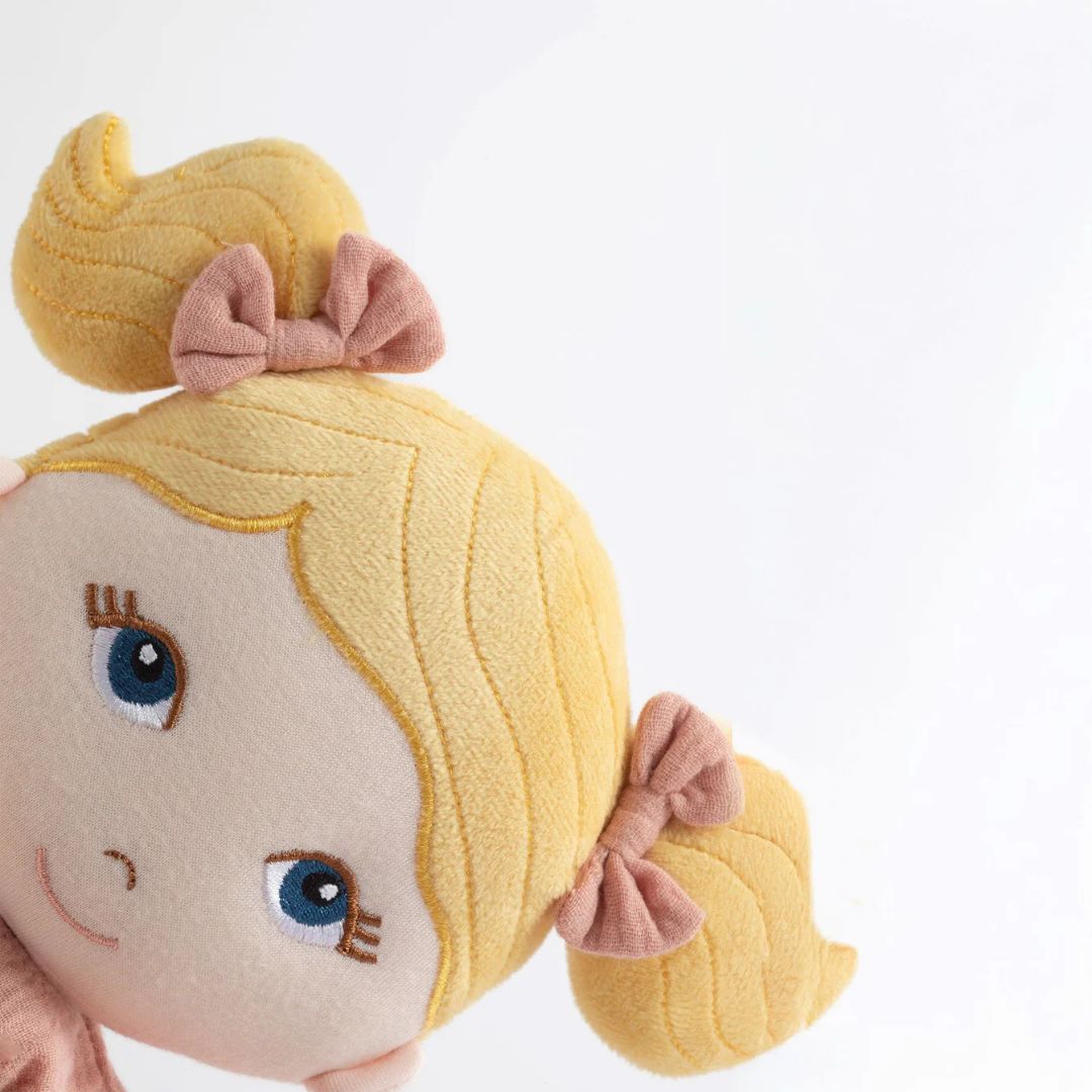 My First Doll - Lola, a soft doll with blonde pigtails and embroidered blue eyes