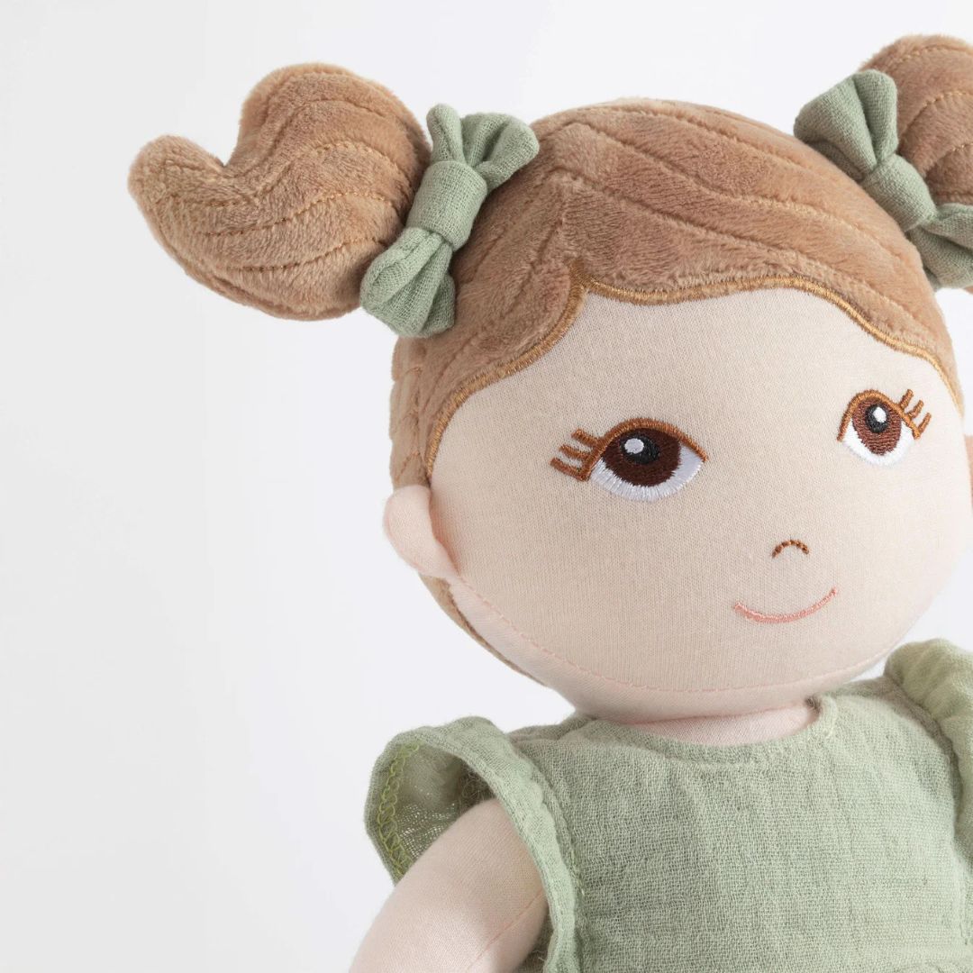 My First Doll - Elena featuring embroidered face, brown pigtails, and sage green dress