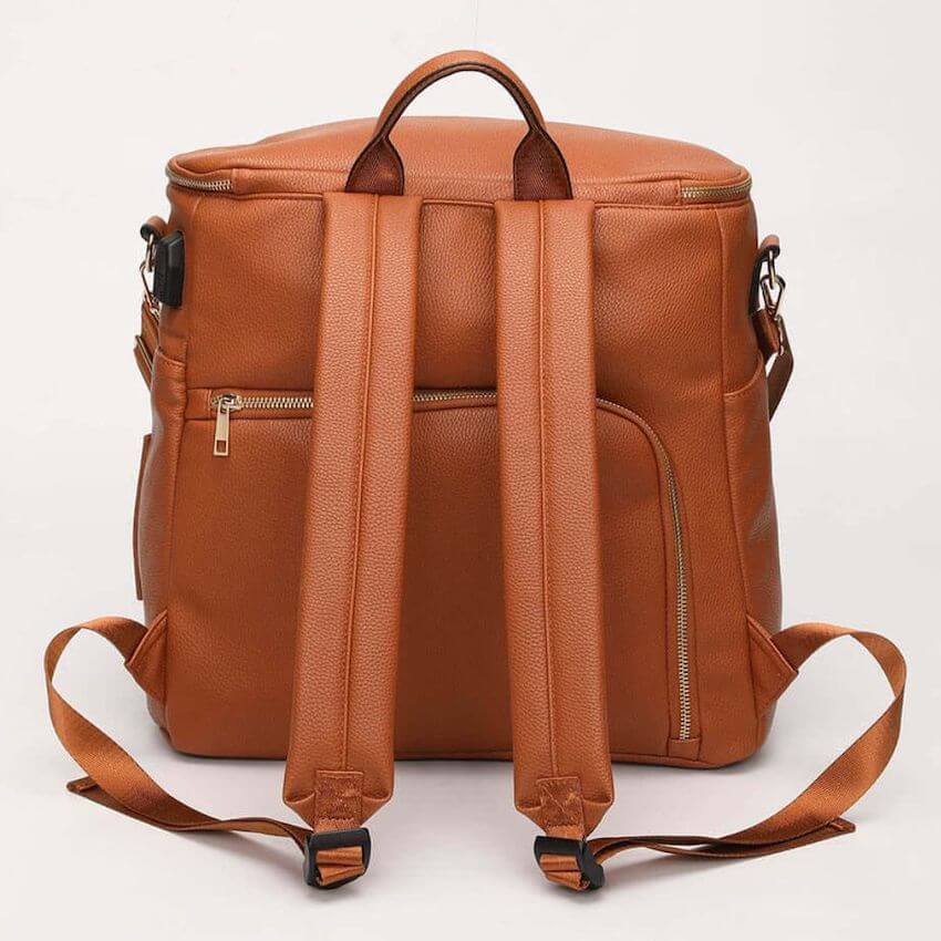Back view of tan vegan leather baby bag showing comfortable padded backpack straps