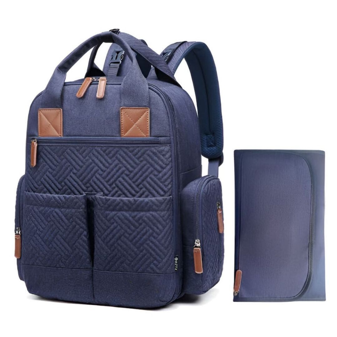 Navy blue quilted nappy bag backpack with tan vegan leather accents and matching change mat