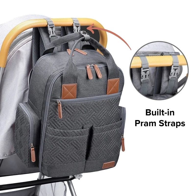Urban nappy backpack in charcoal attached to pram with integrated stroller straps