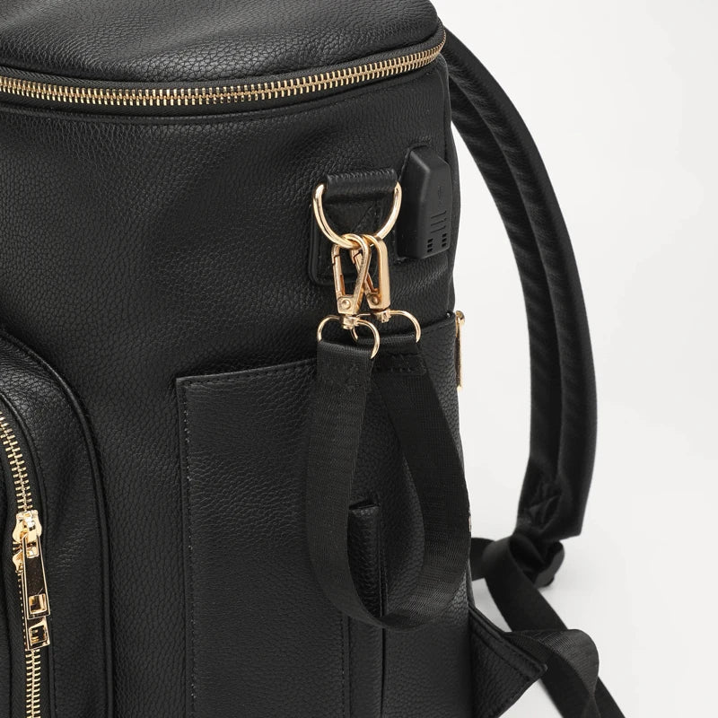 Close-up view of baby changing bag in black vegan leather