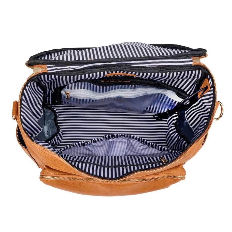 Interior of tan nappy backpack showing multiple organised compartments and pockets