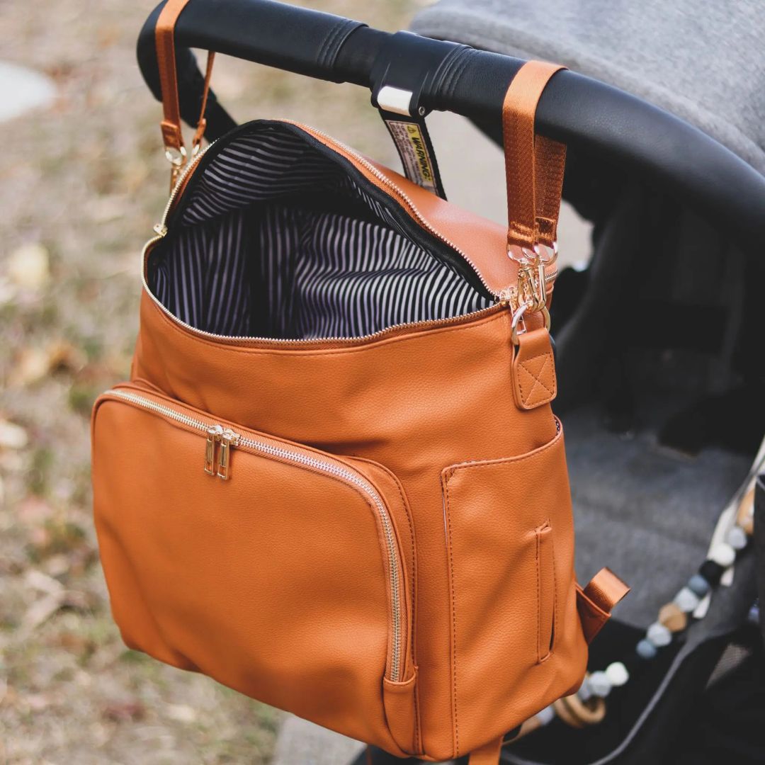 Tan nappy backpack attached to pram with universal straps