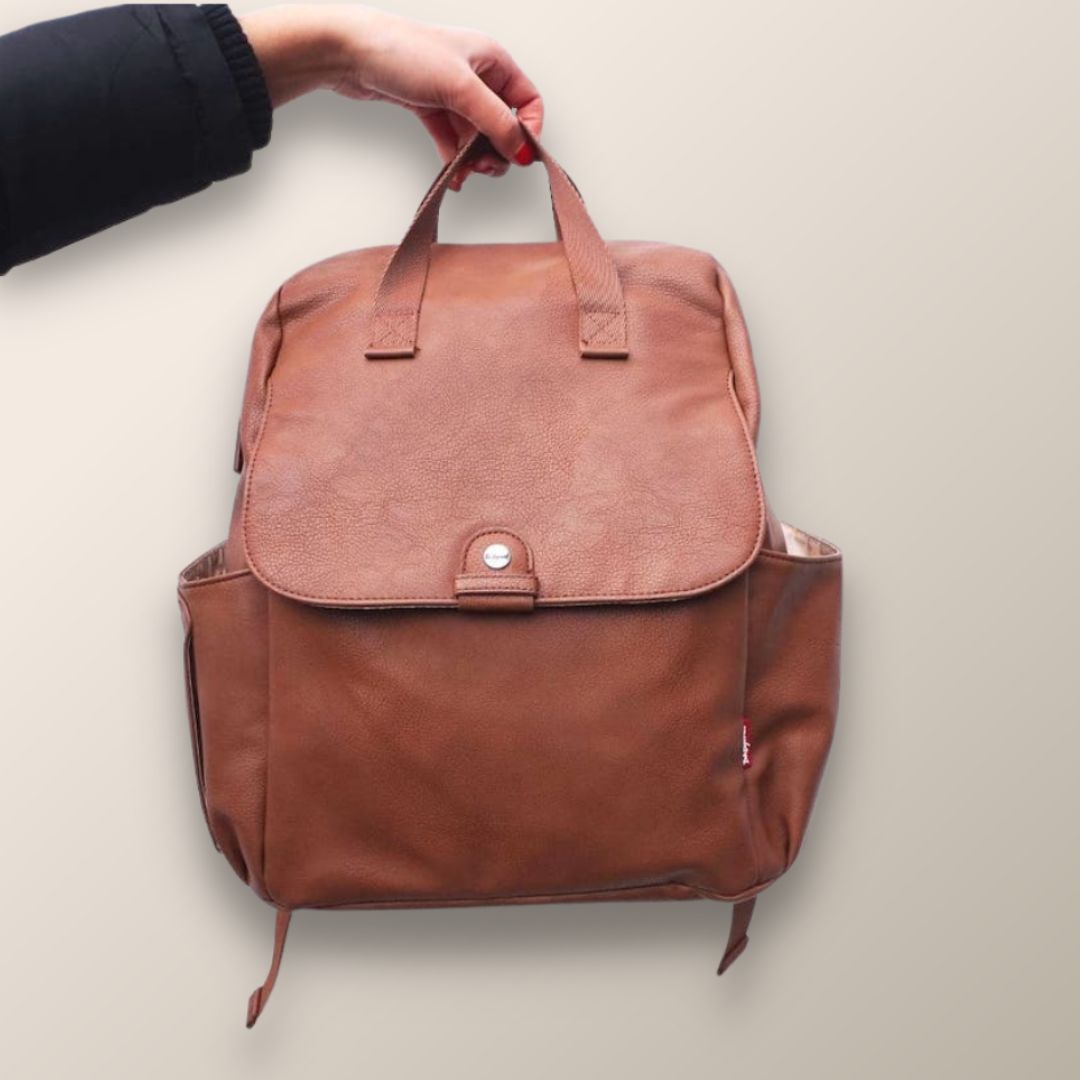 Stylish nappy bag backpack held by parent, practical baby bag