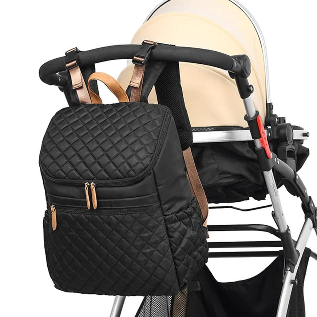 Stylish black quilted nappy backpack attached to stroller with integrated pram straps