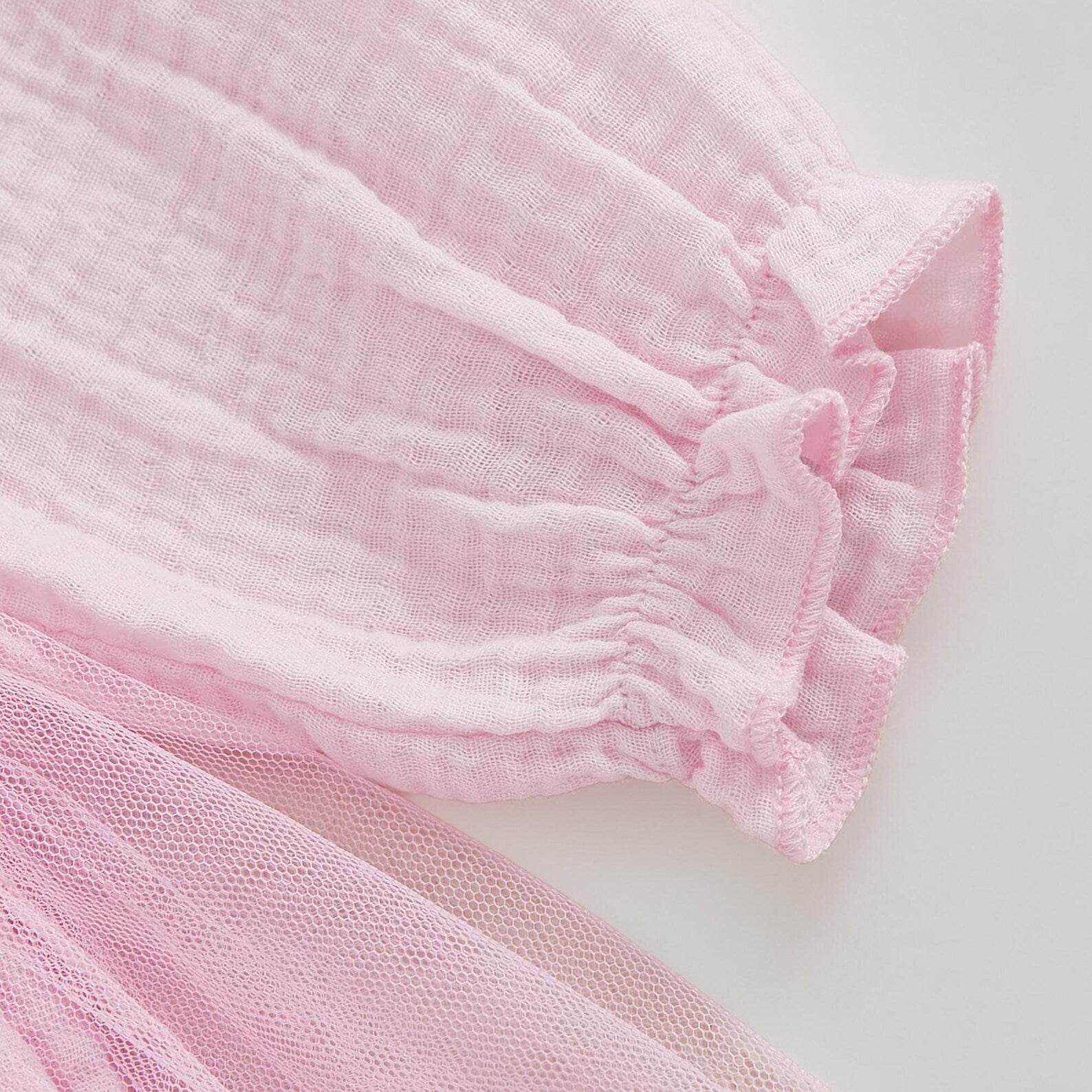Close-up of pink textured sleeve from baby girl first birthday tutu romper