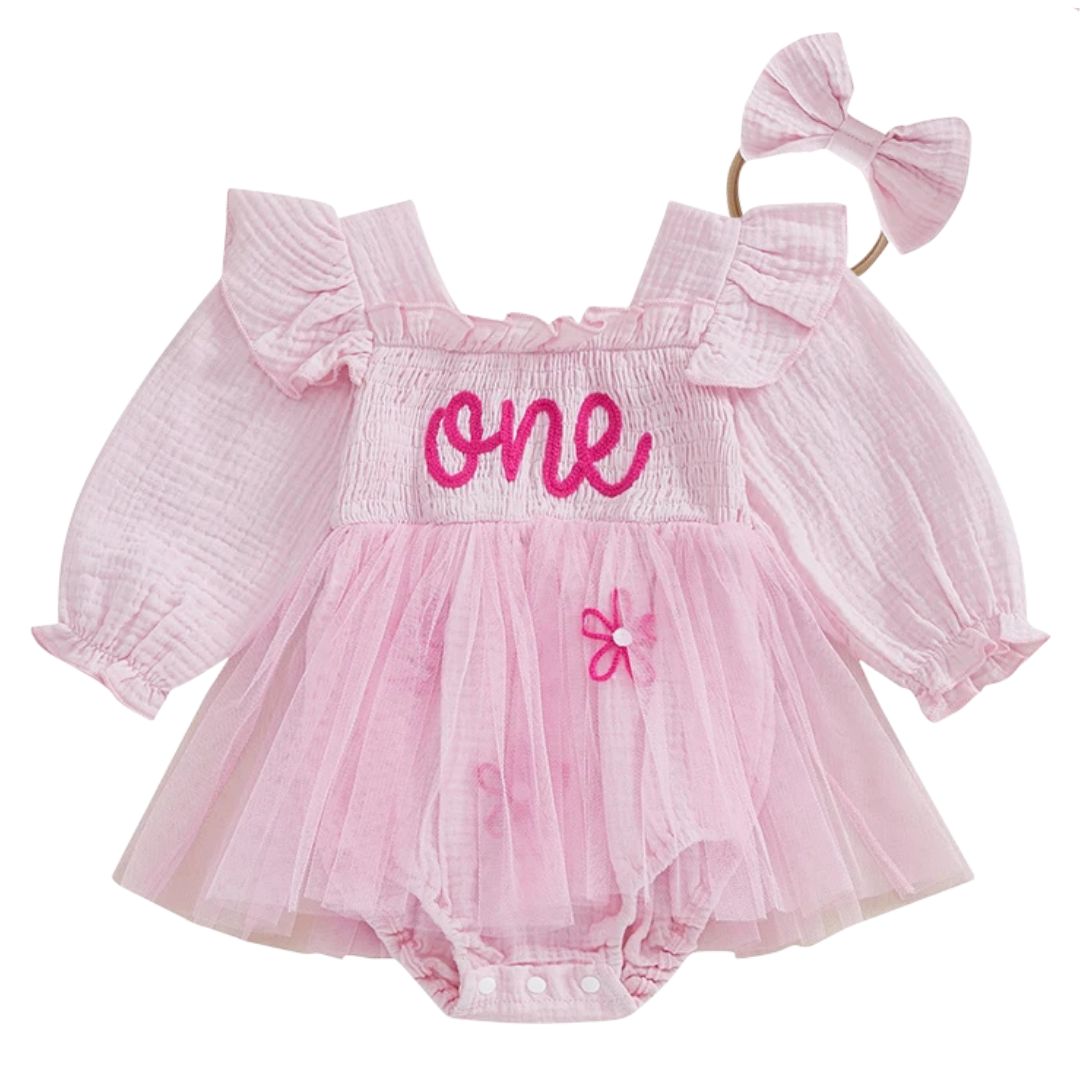 Baby girl pink first birthday tutu romper with embroidered "one" script, puff sleeves, tulle skirt overlay and matching pink bow headband