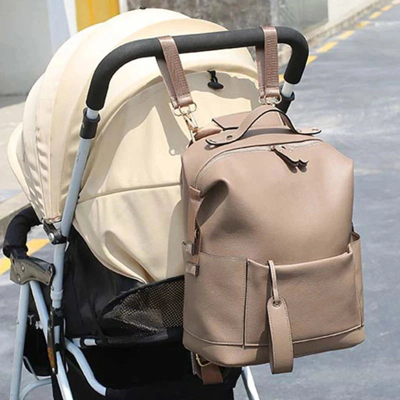 Penelope Nappy Bag in camel - attached to pram