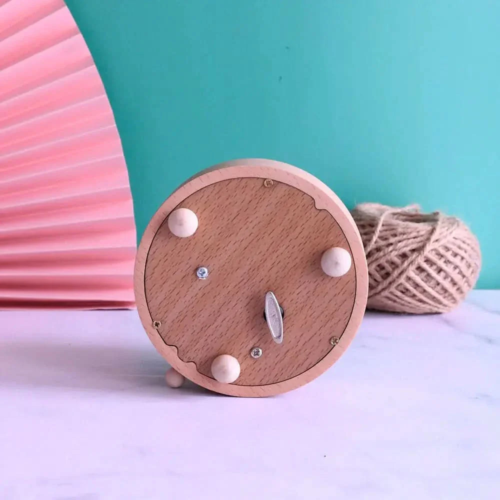 Musical Christmas box, showing underside with the winding mechanism