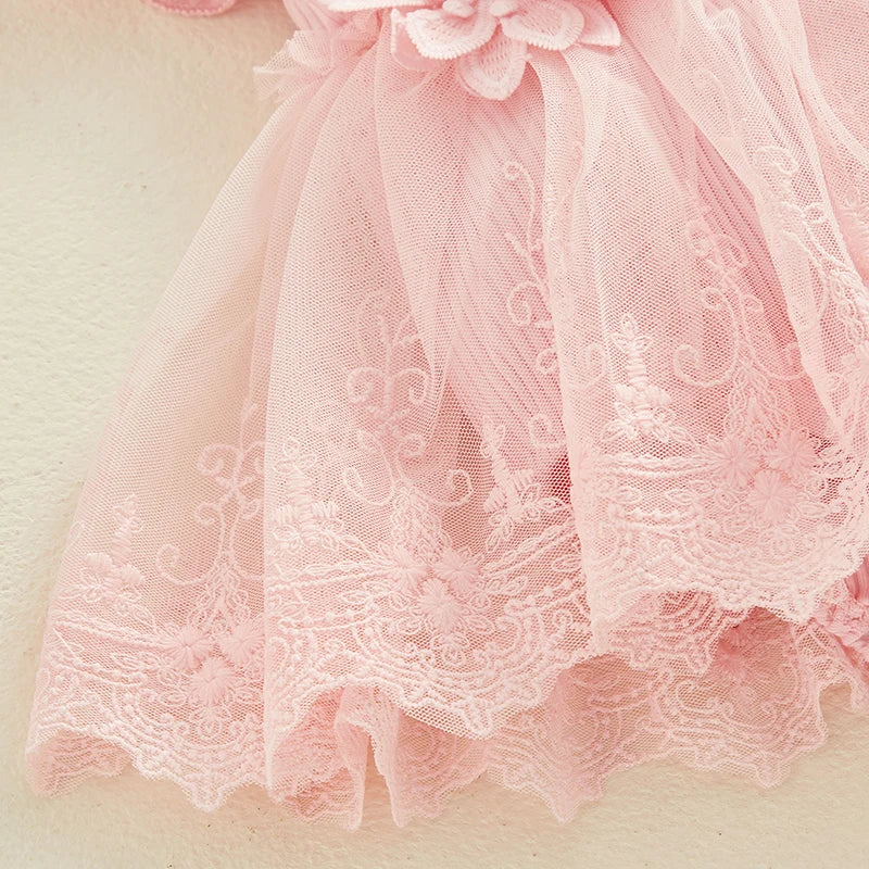 Close-up of a pink lace dress with floral details