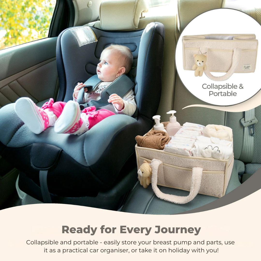 Baby in car seat with collapsible oatmeal nappy caddy for organising essentials on the go.