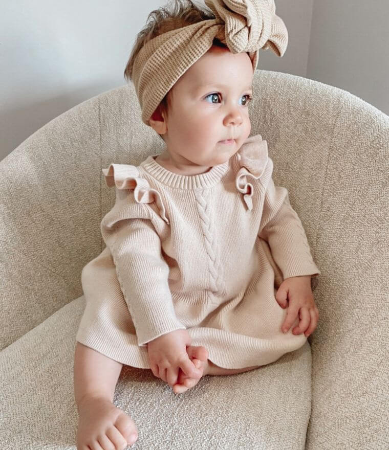 Toddler girl wearing Poppy Winter Knit Dress in oatmeal from Lulu Babe