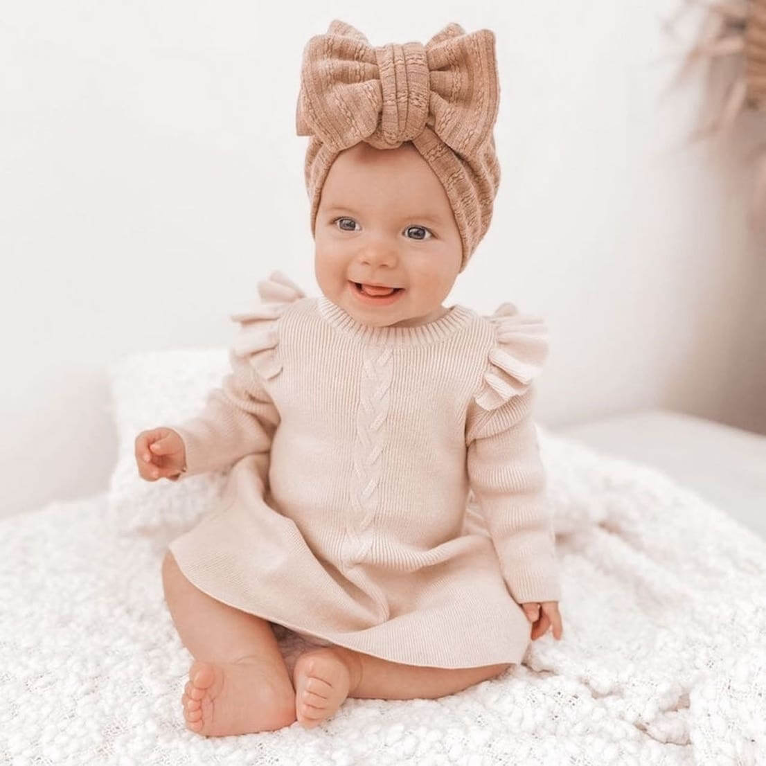 Baby girl wearing our Poppy Winter Dress in Oatmeal