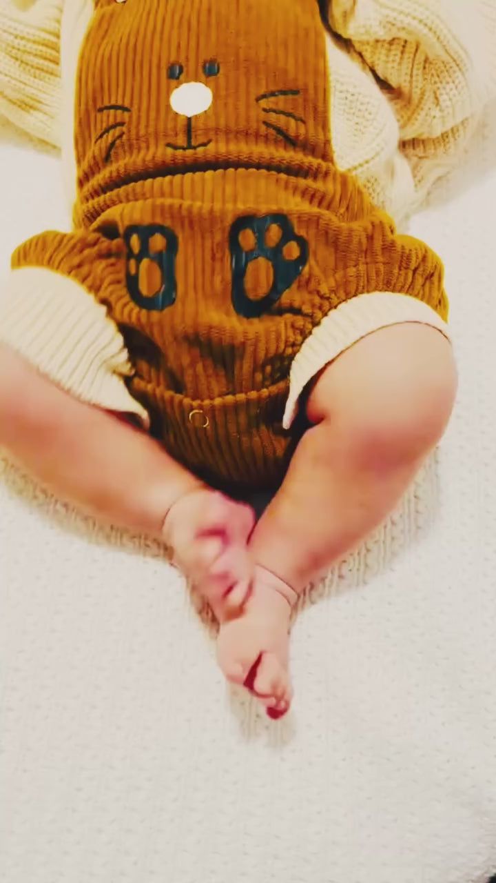 Video of a baby boy wearing the Corduroy Bunny Romper from Lulu Babe, a soft corduroy Easter outfit with bunny ears and paw print details