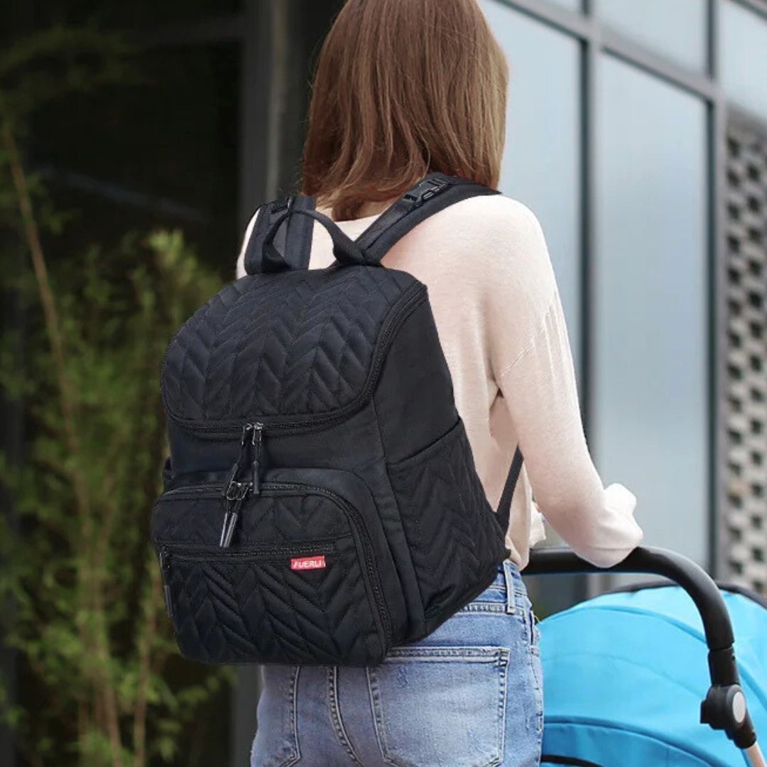 Mum carrying a stylish Quilted Chevron Nappy Backpack.