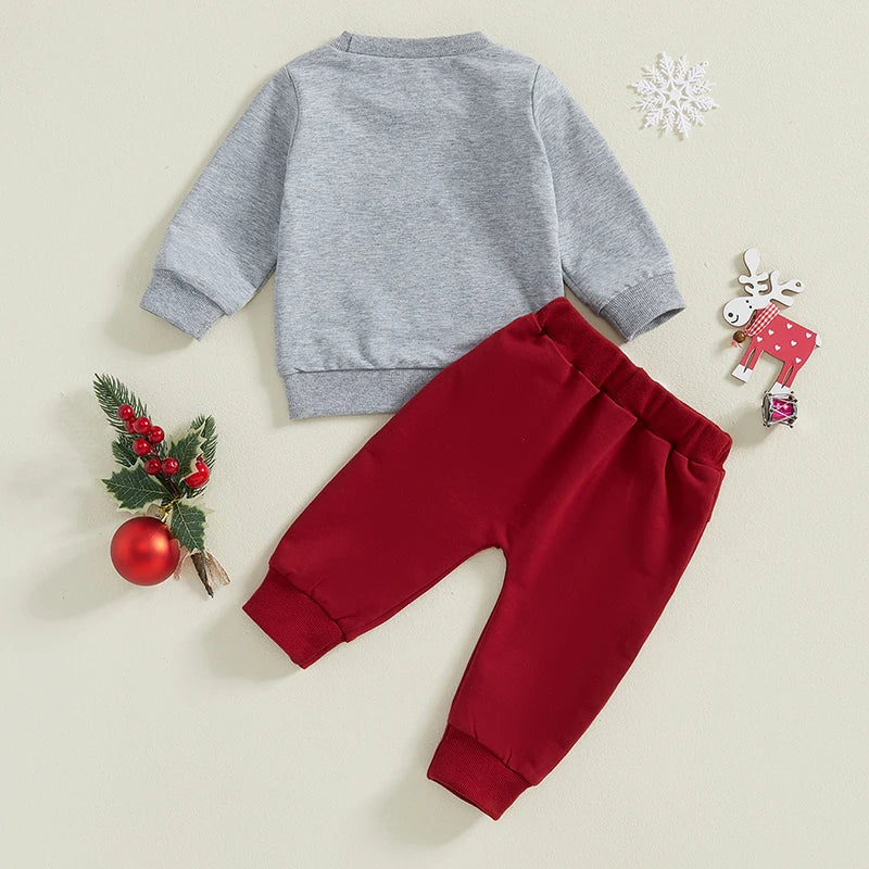 Baby Christmas outfit featuring a grey pullover and red trackie pants for festive occasions.