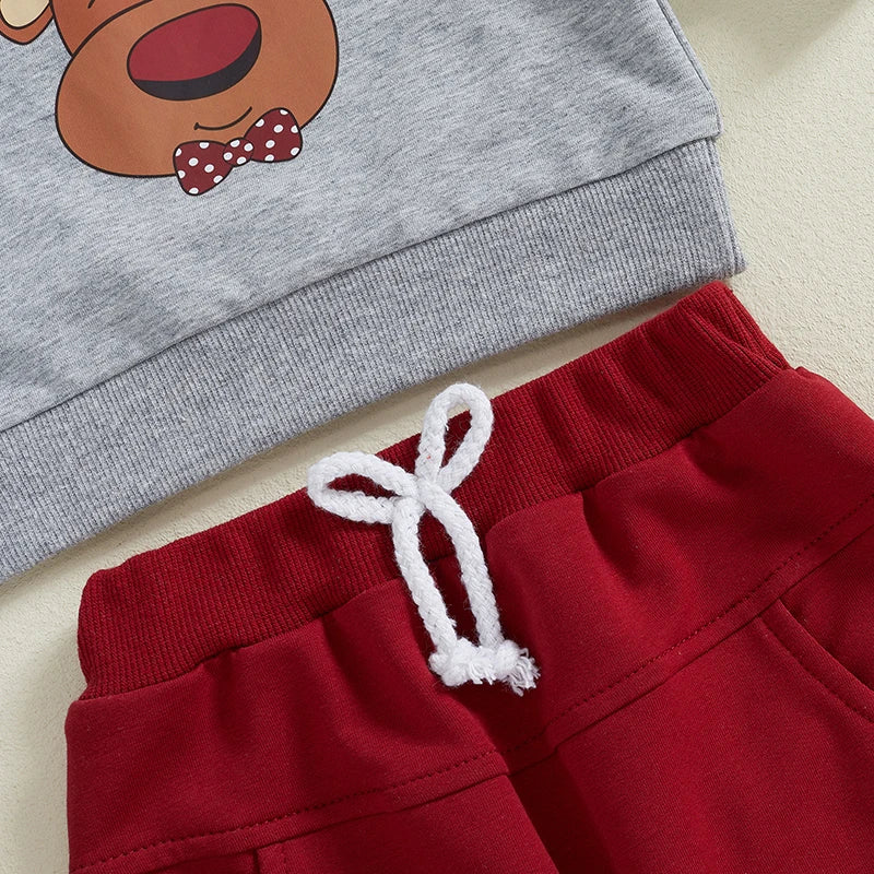 Close-up of Reindeer Tracksuit Set featuring grey pullover with reindeer graphic and red trackie pants for baby Christmas outfit.