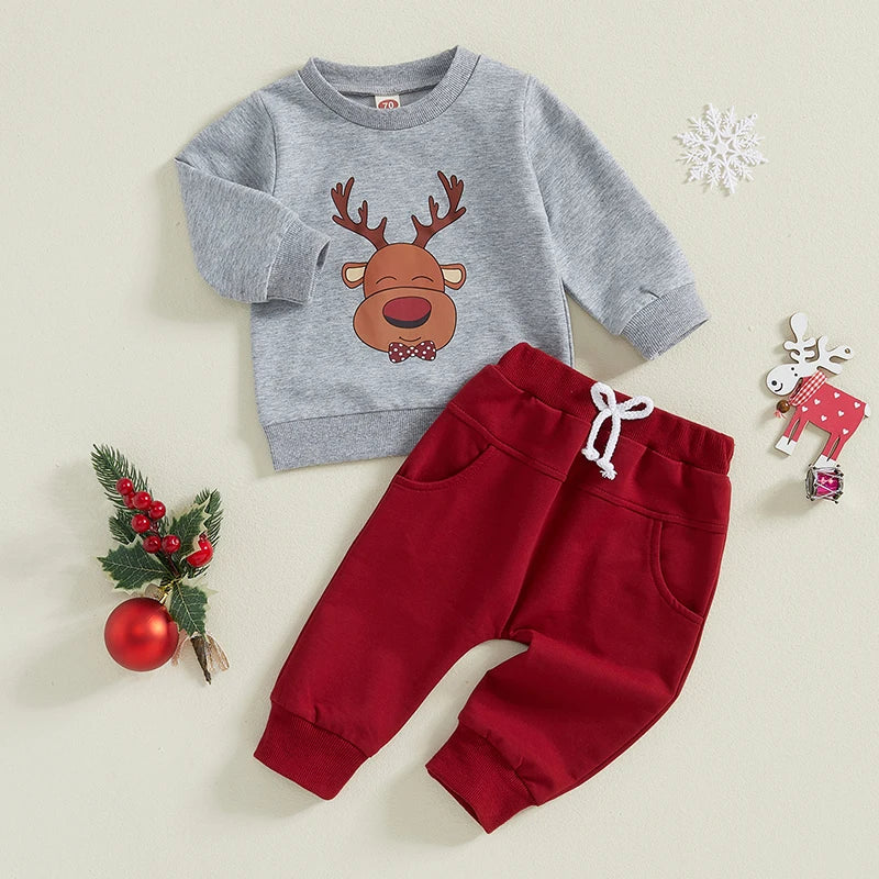 Adorable baby Christmas outfit featuring a grey reindeer pullover and red trackie pants for festive comfort.