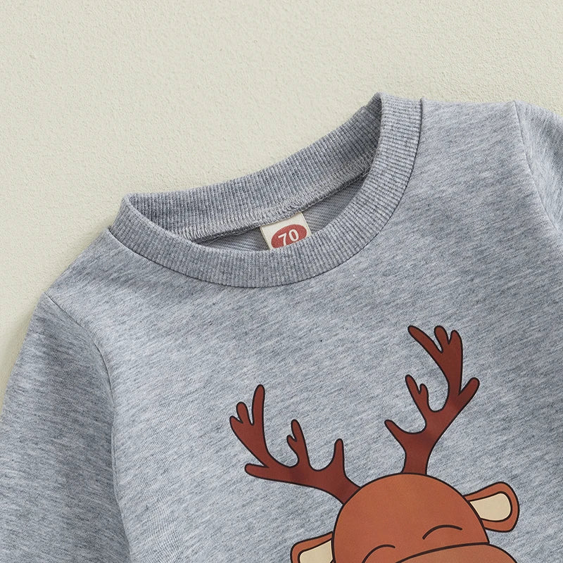 Close-up of grey pullover top with a reindeer graphic, part of a baby Christmas outfit for festive celebrations.