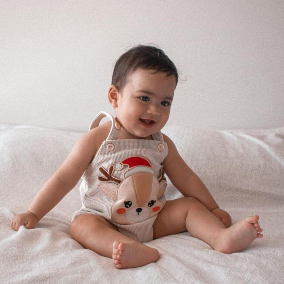 Baby boy wearing our Reindeer Corduroy Romper in cream