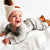 Smiling baby boy wearing ribbed bodysuit and pants set from Lulu Babe, in grey
