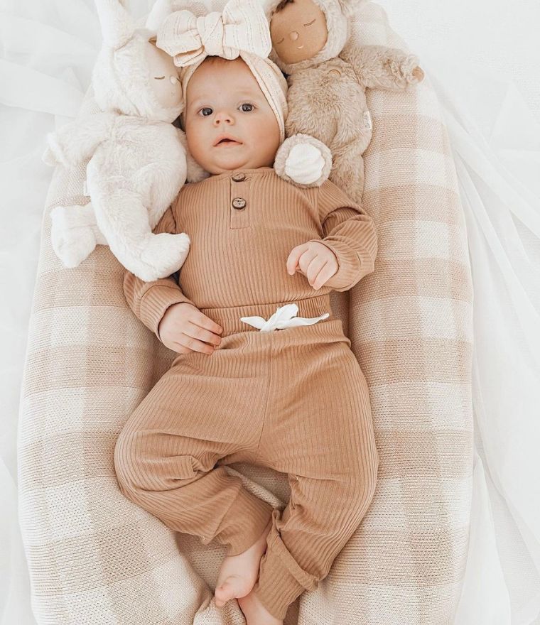 Baby girl wearing ribbed long sleeve bodysuit and pants set in latte, from Lulu Babe