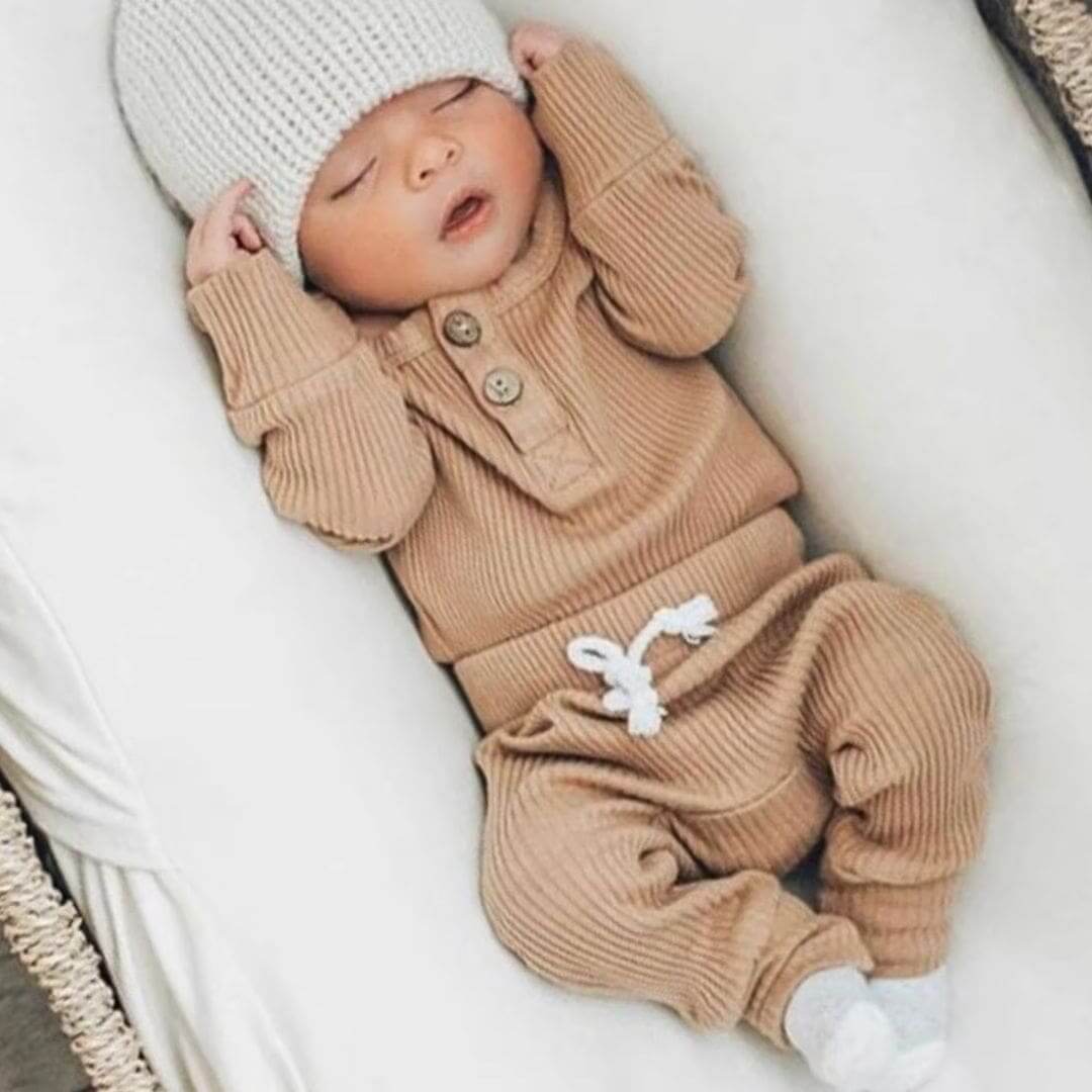Baby boy wearing ribbed long sleeve bodysuit and pants set in latte, from Lulu Babe