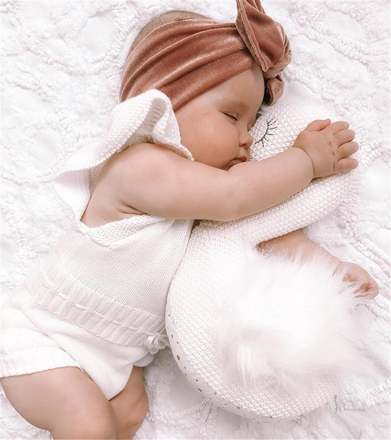 Baby girl wearing white knit ruffle onesie