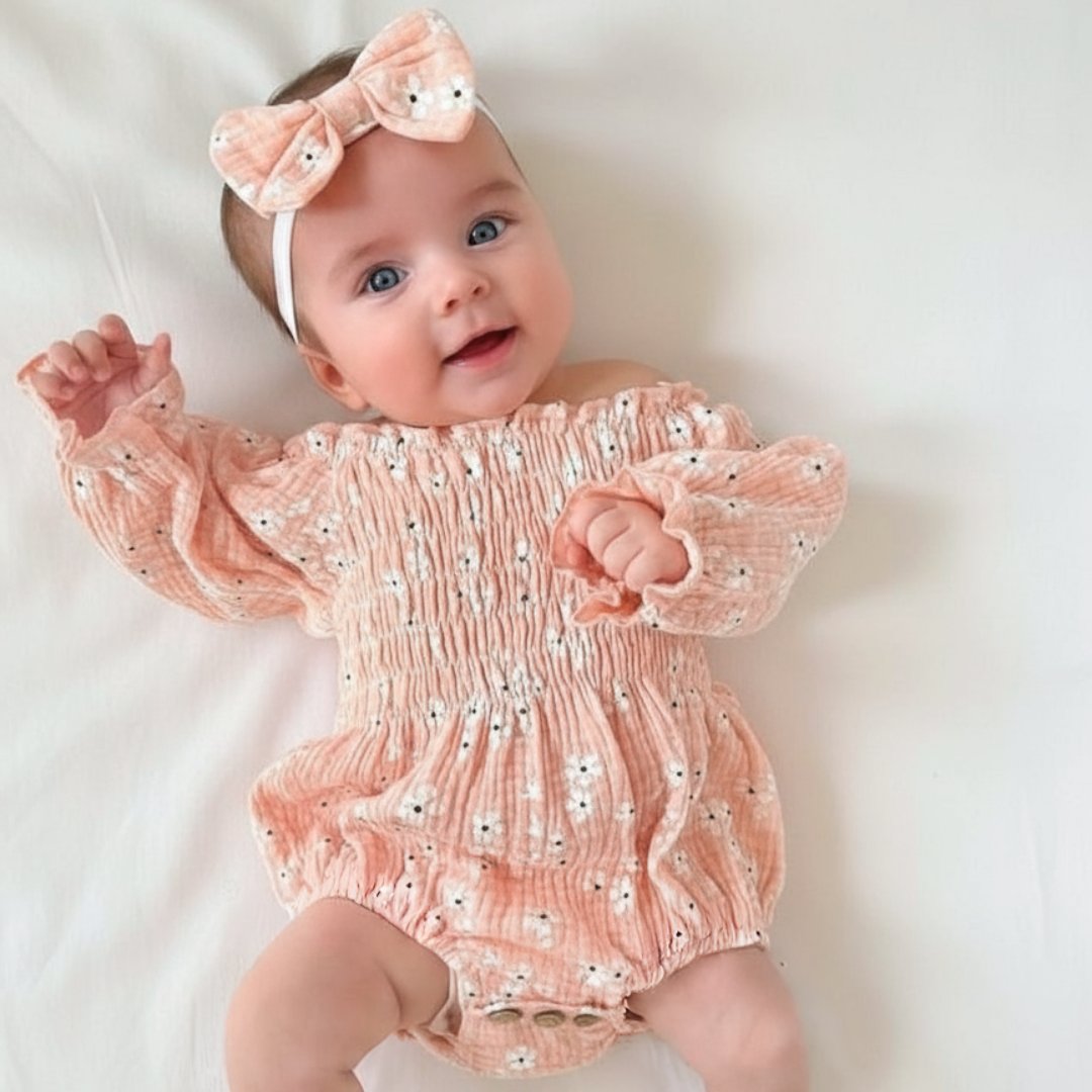 Baby girl wearing a pink boho romper