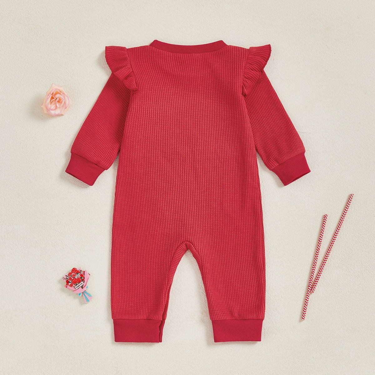 Back view of a red baby girl Christmas outfit with ruffle shoulders, ideal long sleeve festive onesie for holiday celebrations.