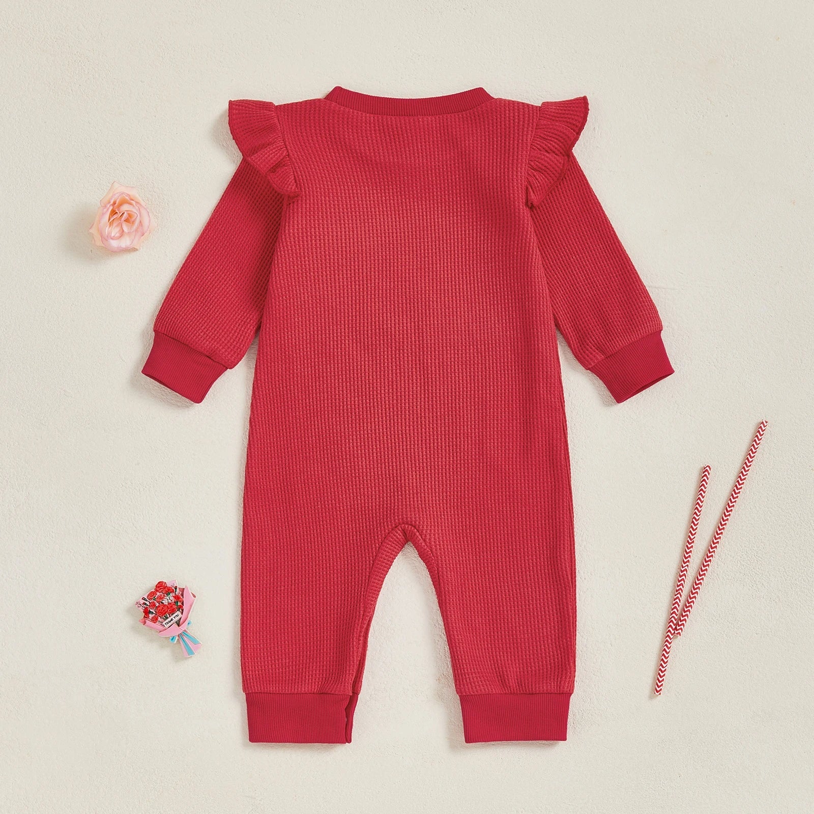 Back view of a red baby girl Christmas outfit with ruffle shoulders, ideal long sleeve festive onesie for holiday celebrations.